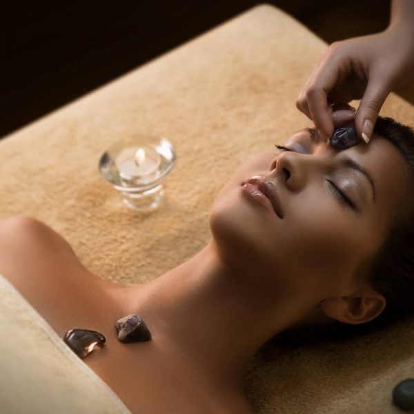 Beautiful girl has massage with chakra-stones Massage with special chakra-stones. Luxury addition to the traditional hot stone therapy.