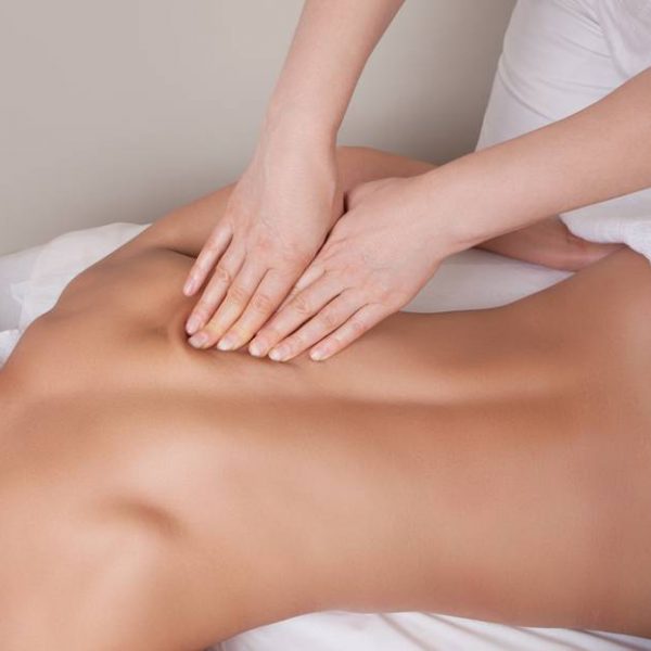 Connective tissue massage on a muscle group of a woman's back