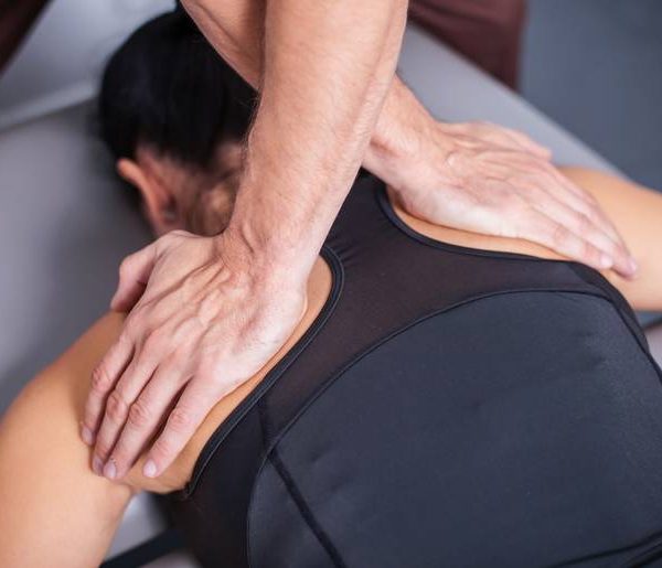 Professional back massage in spa studio.