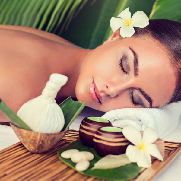 Body care. Spa body massage treatment with hot  herbal ball for deep relaxation . Woman having massage in the spa salon