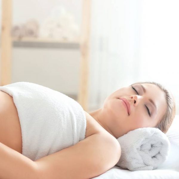 Young beautiful pregnant woman relaxing in spa salon