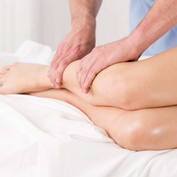Physical therapist doing lymphatic drainage Physical therapist doing lymphatic drainage for the legs